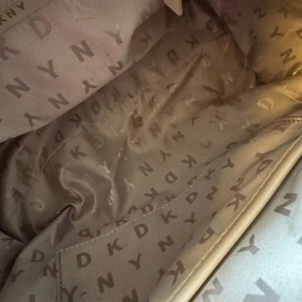 DKNY brown monogram bag is a DKNY Bryant Boston tote featuring an all-over logo